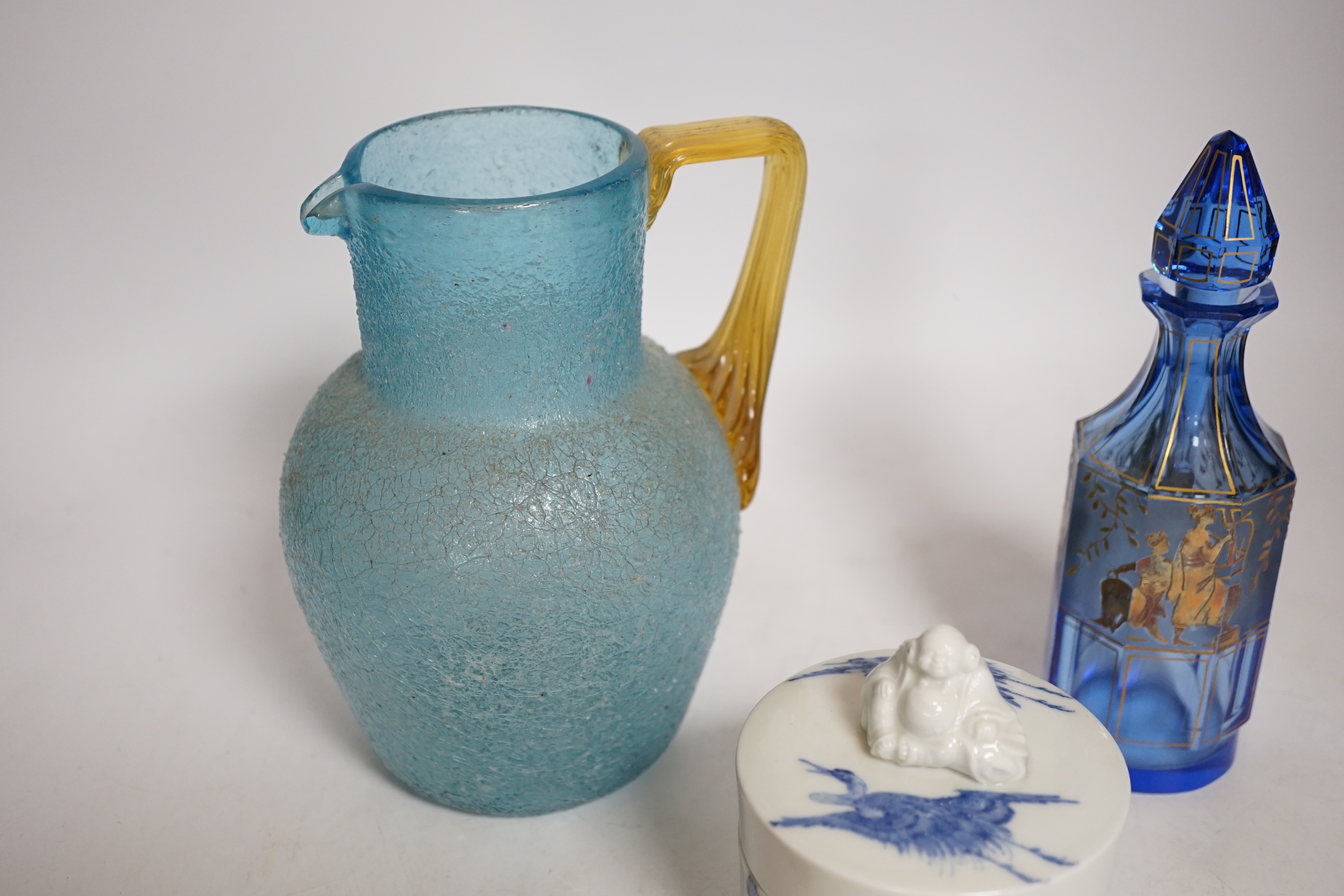 A 19th century Japanese Hirado blue and white cylindrical box and cover, height 8cms, a gold classically decorated glass bottle and a frosted glass jug and wooden pot (4)